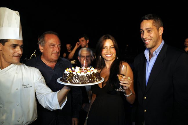Sofia Vergara, black dress, bracelet, champagne glass, earrings, watch, birthday cake